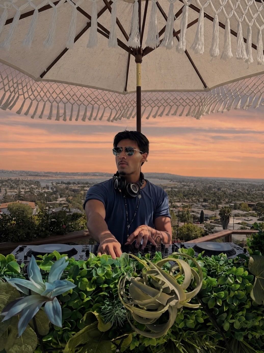 Armaan Damani playing a sunset rooftop DJ set overlooking San Diego